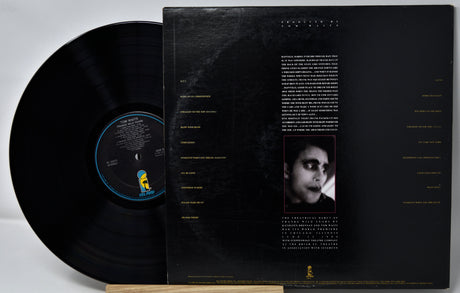 Vinyl record with cover featuring a black and white portrait and text on a gray background