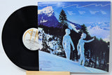 Vinyl record with a colorful landscape design on a clear plastic cover