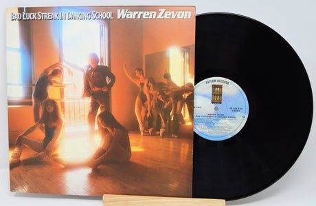 Vinyl record with cover featuring a dancer and text 'Bad Luck Streak In Dancing School Warren Zevan'.
