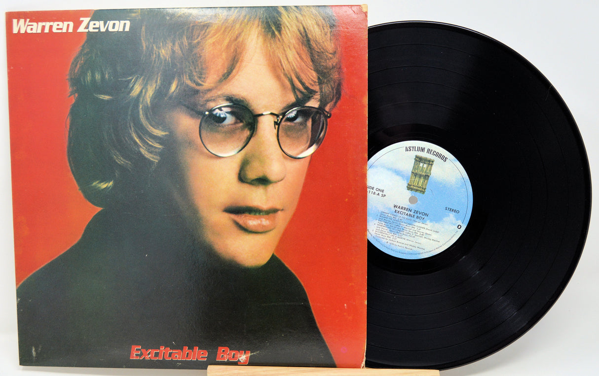 Vinyl record with cover featuring a person's face on a red background