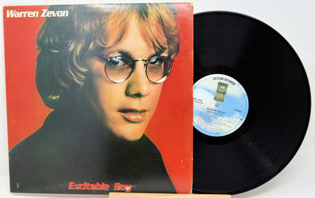 Vinyl record with cover featuring a person's face on a red background