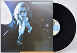 Warren Zevon vinyl record album with the LP partially pulled from the jacket, photographed against a plain light background.