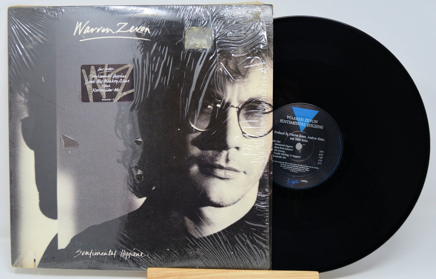 Vinyl record with cover featuring a person and decorative elements on a desert landscape.