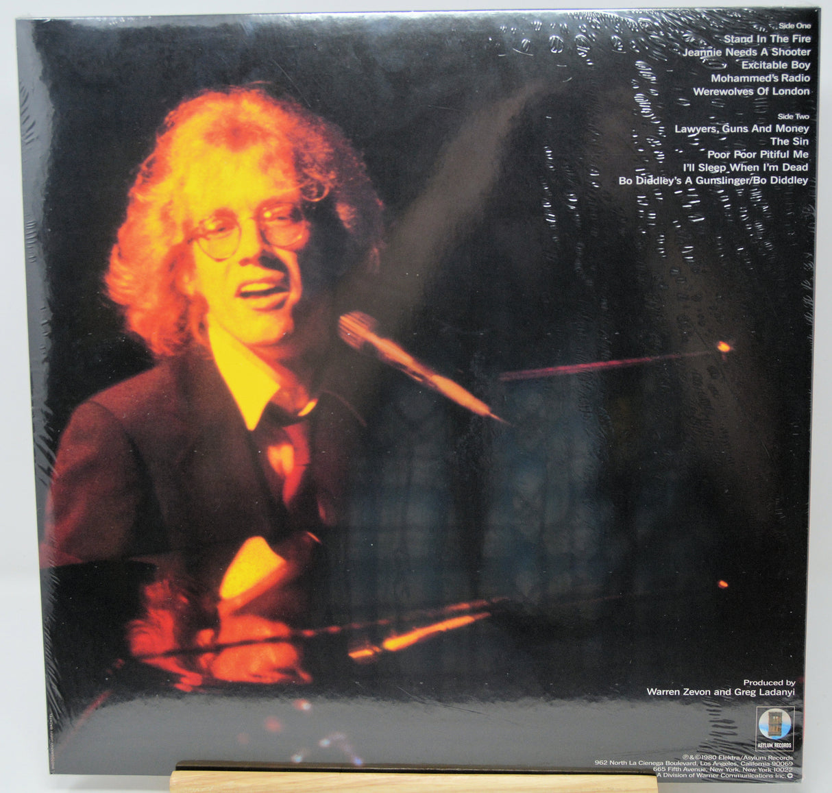 Vinyl record album cover for Warren Zevon's 'Roads' LP, showing the back side with tracklist text and a warm-toned portrait of the artist under dramatic lighting.
