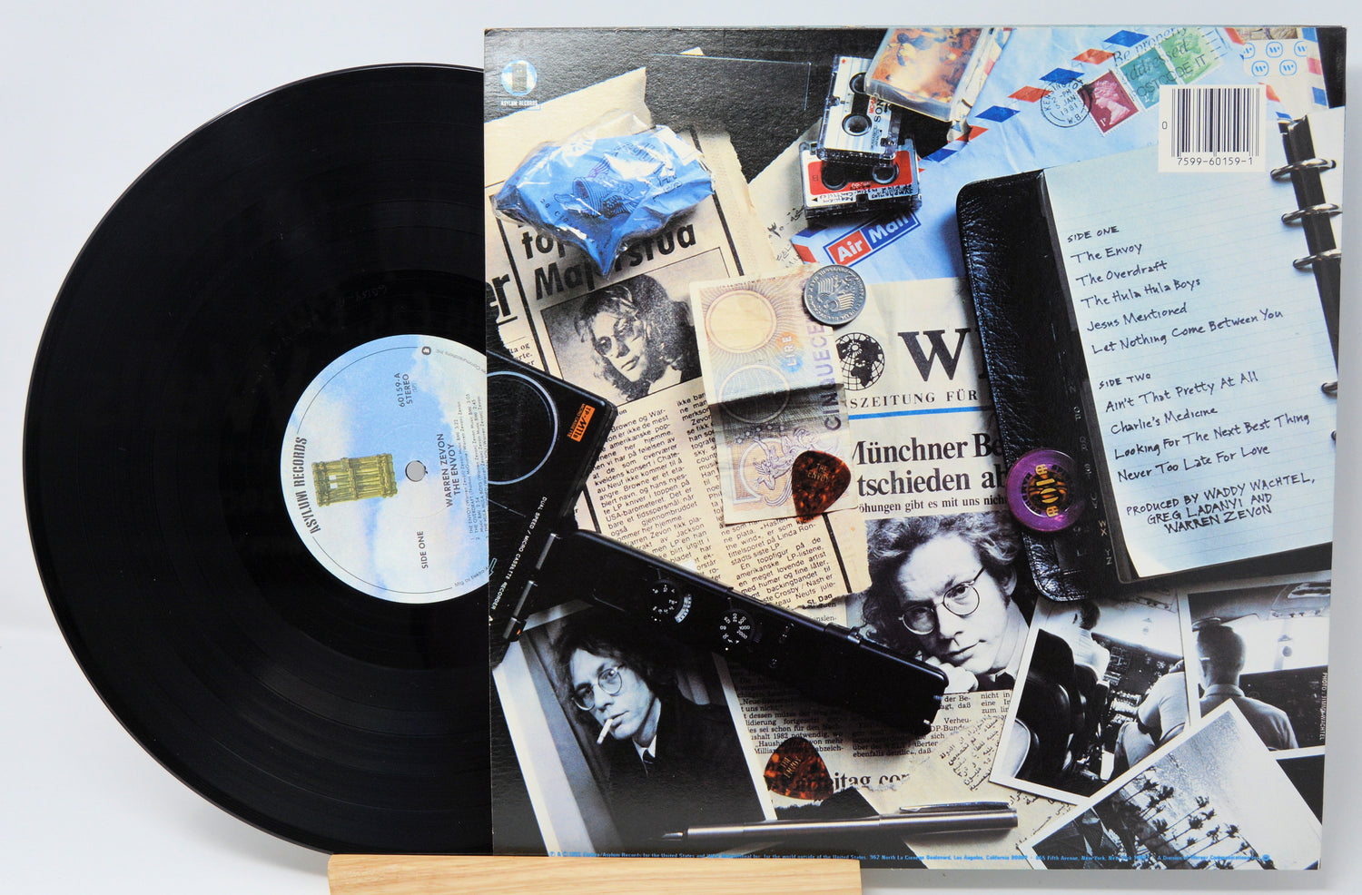 Vinyl record with collage-style cover art featuring various images and text.