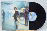 A used vinyl record of Warren Zevon's album 'The Envoy' with the cover image featuring the artist next to an airplane.