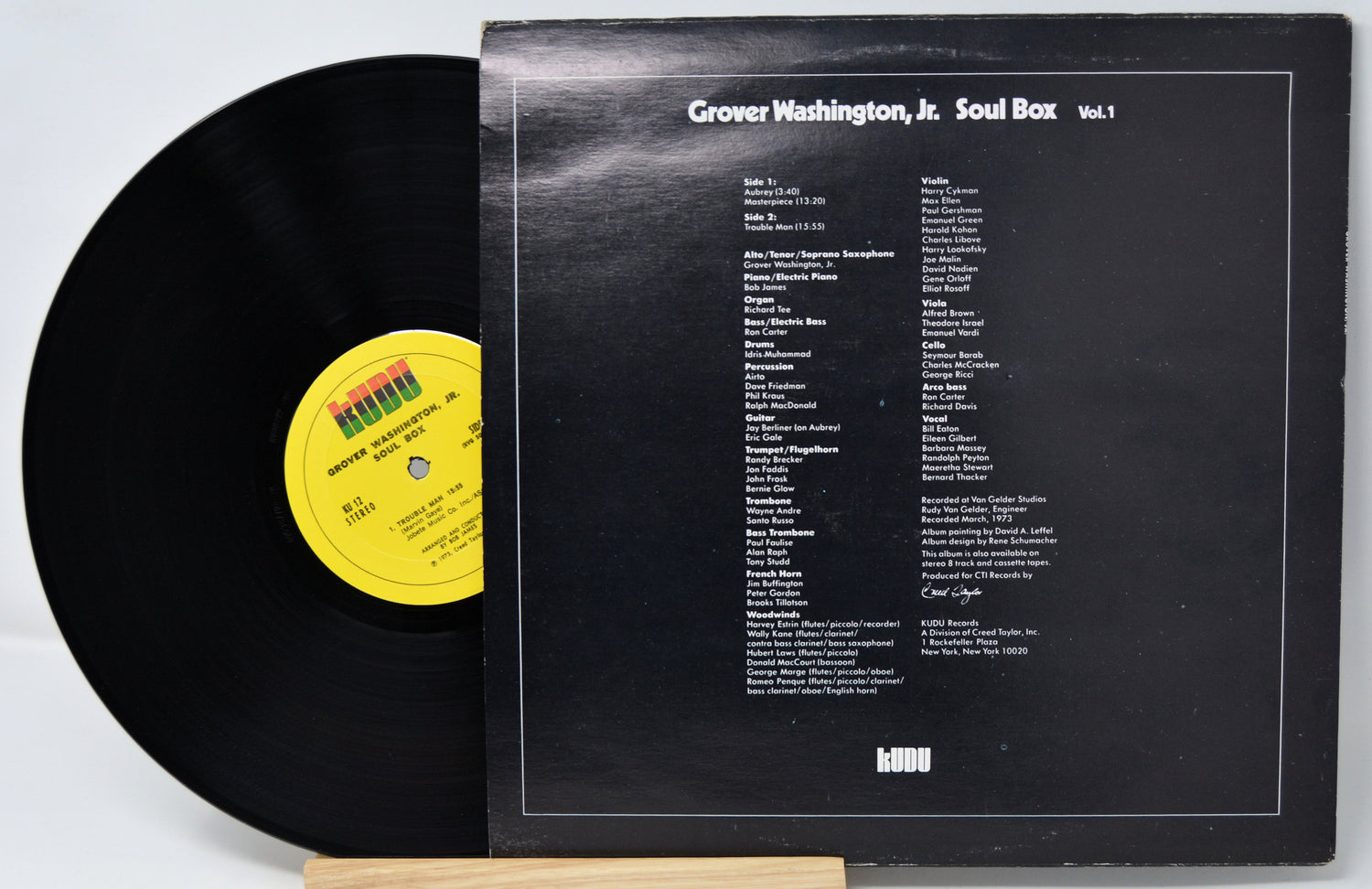 Vinyl record with a black cover displaying track listings on a white background