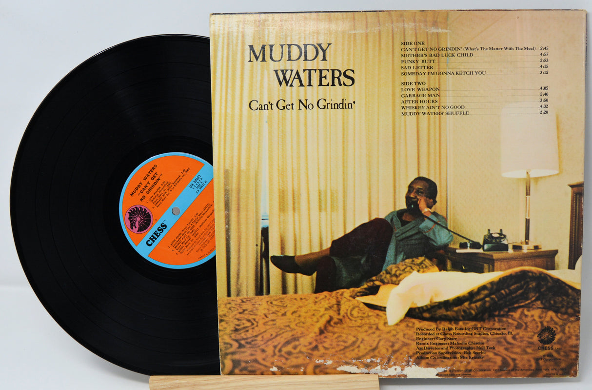Vinyl record with cover featuring a man in a room, 'Muddy Waters' album title on top.