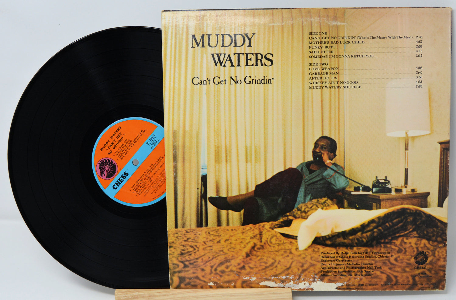 Vinyl record with cover featuring a man in a room, 'Muddy Waters' album title on top.