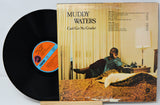 Vinyl record with cover featuring a man in a room, 'Muddy Waters' album title on top.