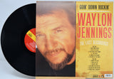 Waylon Jennings 'Goin' Down Rockin'' 'The Last Recordings' vinyl record album with the black LP partially pulled from the printed cover, photographed on a white background.