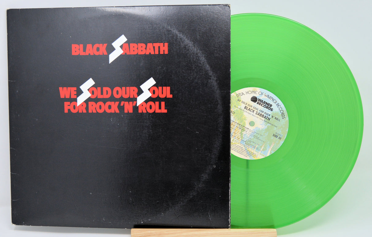Front cover of Black Sabbath's We Sold Our Soul for Rock 'n' Roll album with neon green vinyl partially visible