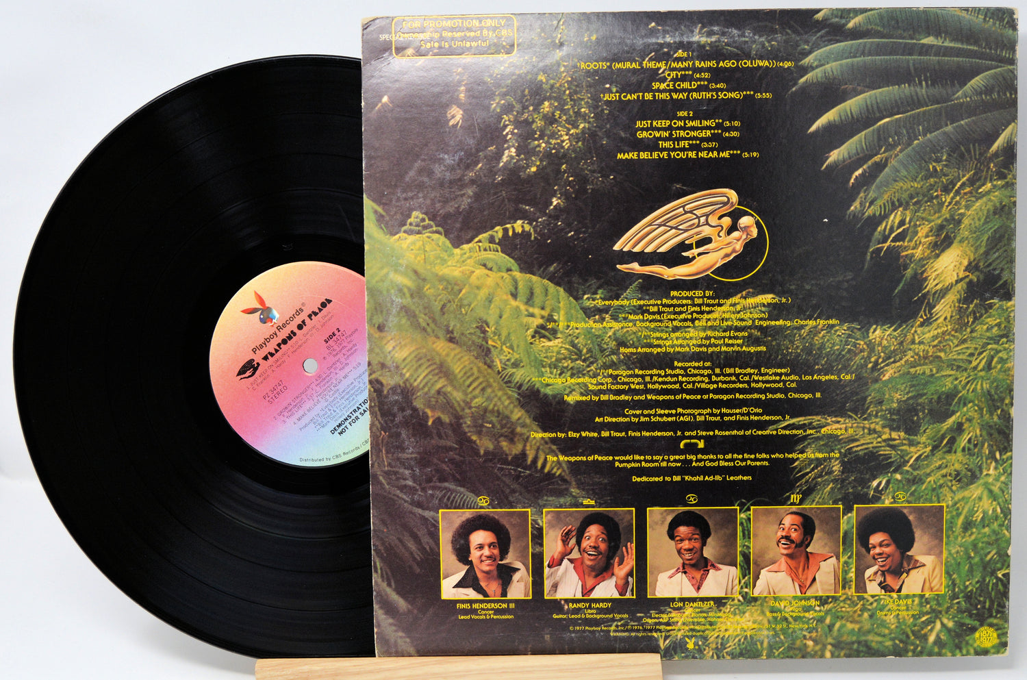 Vinyl record with a colorful label featuring images of people and nature.