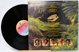 Vinyl record with a colorful label featuring images of people and nature.