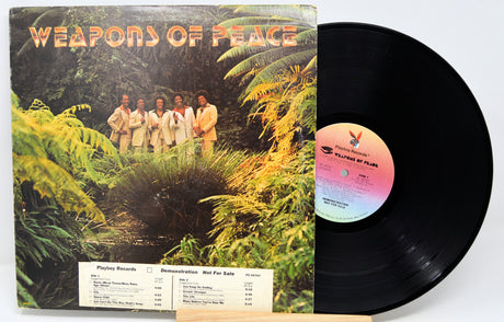 Vinyl record with cover featuring a group of people in a jungle setting titled 'Weapons of Peace'.