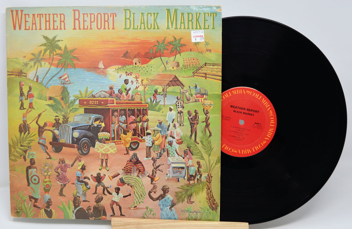 Vinyl record with colorful cover featuring people and a bus, labeled 'Weather Report Black Market'.