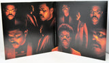 Foldout poster with multiple portraits of a man on a dark background