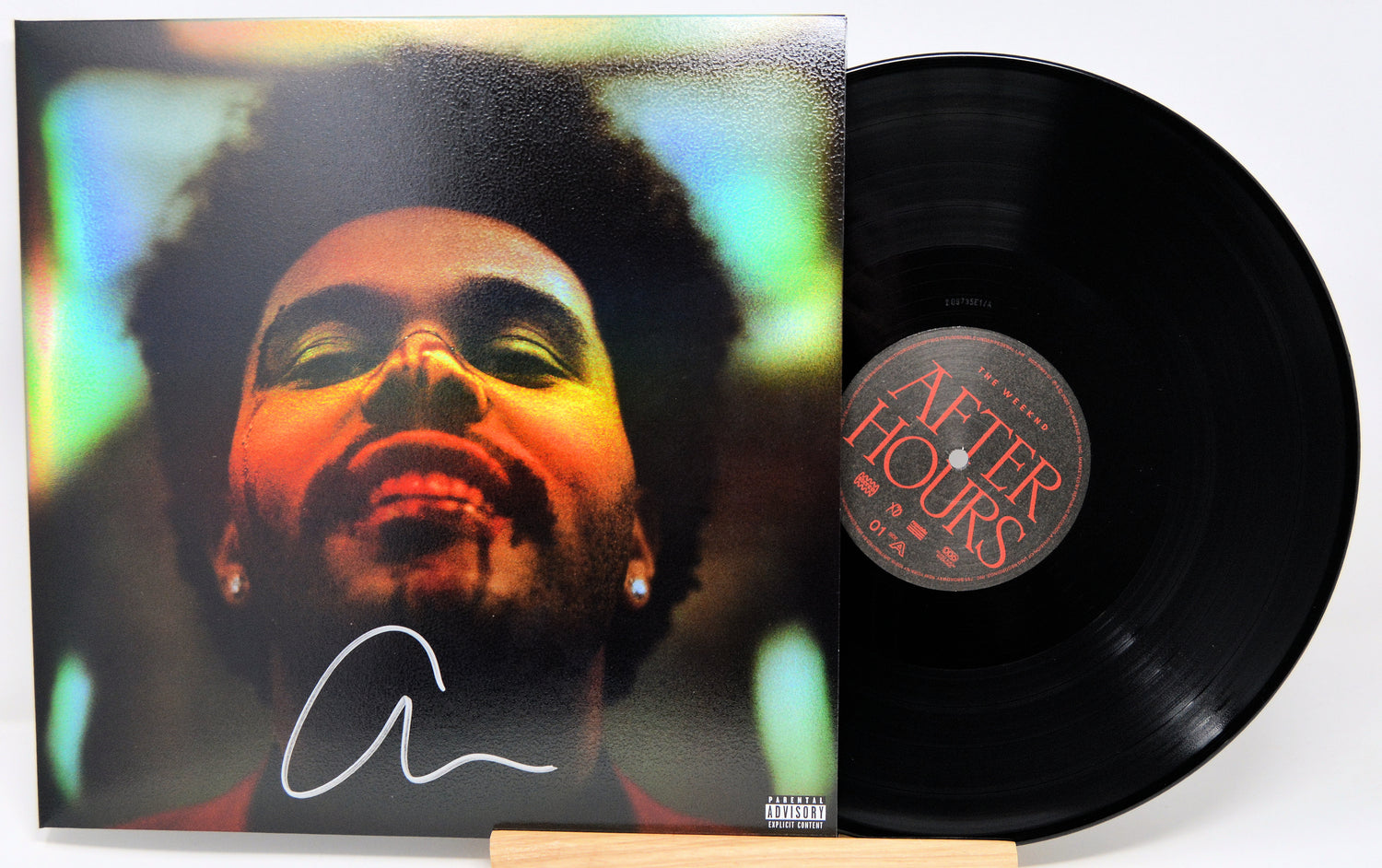 Vinyl record with cover featuring a face and 'After Hours' label on a white background