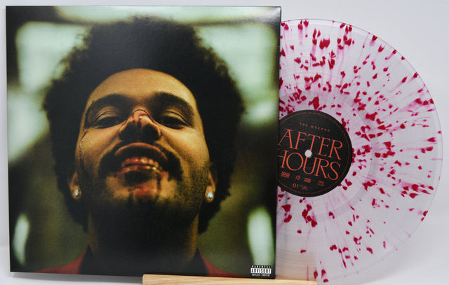 Vinyl record with a cover featuring a person's face and a splatter design.