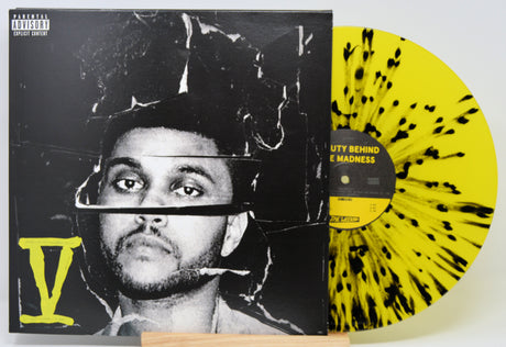 Vinyl record with a black and yellow design and a cover featuring a person's face.