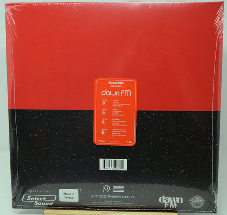 Packaged vinyl record with 'dawn FM' label on a red and black background