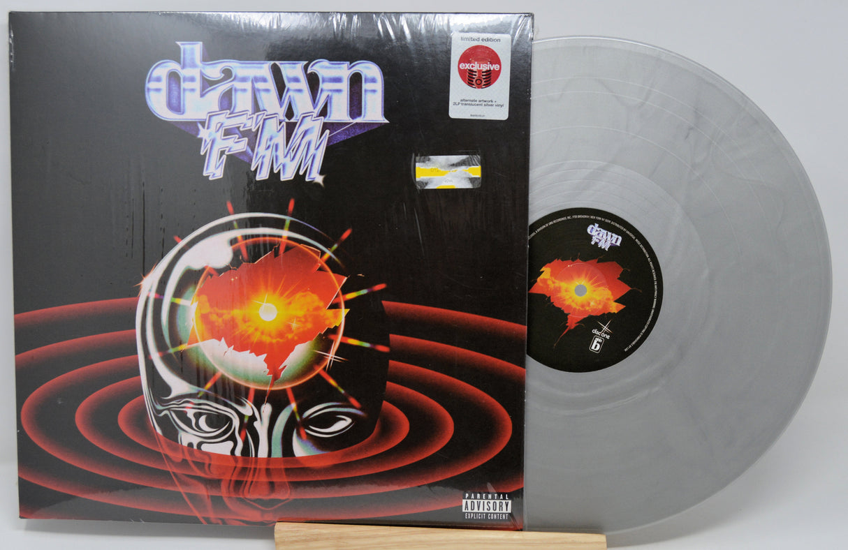 Vinyl record with cover featuring a stylized face and abstract design on a white background