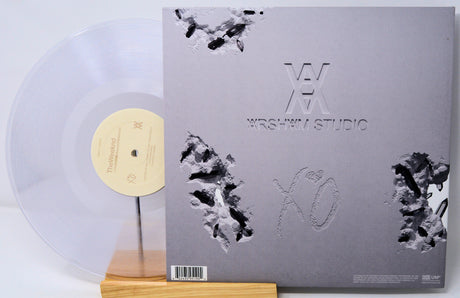 Vinyl record with a gray cover featuring black abstract designs and 'Wesley I. Studio' branding.