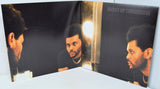 Vinyl record with a cover featuring a person's face and album title 'Hurry Up Tomorrow'.