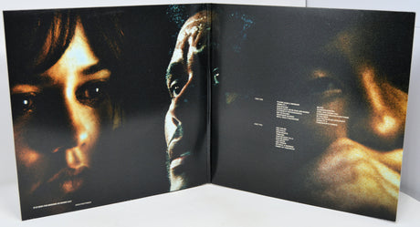Open book showing close-up images of a person's face with a dark background
