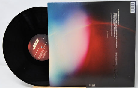 Vinyl record with a colorful album cover on a white background