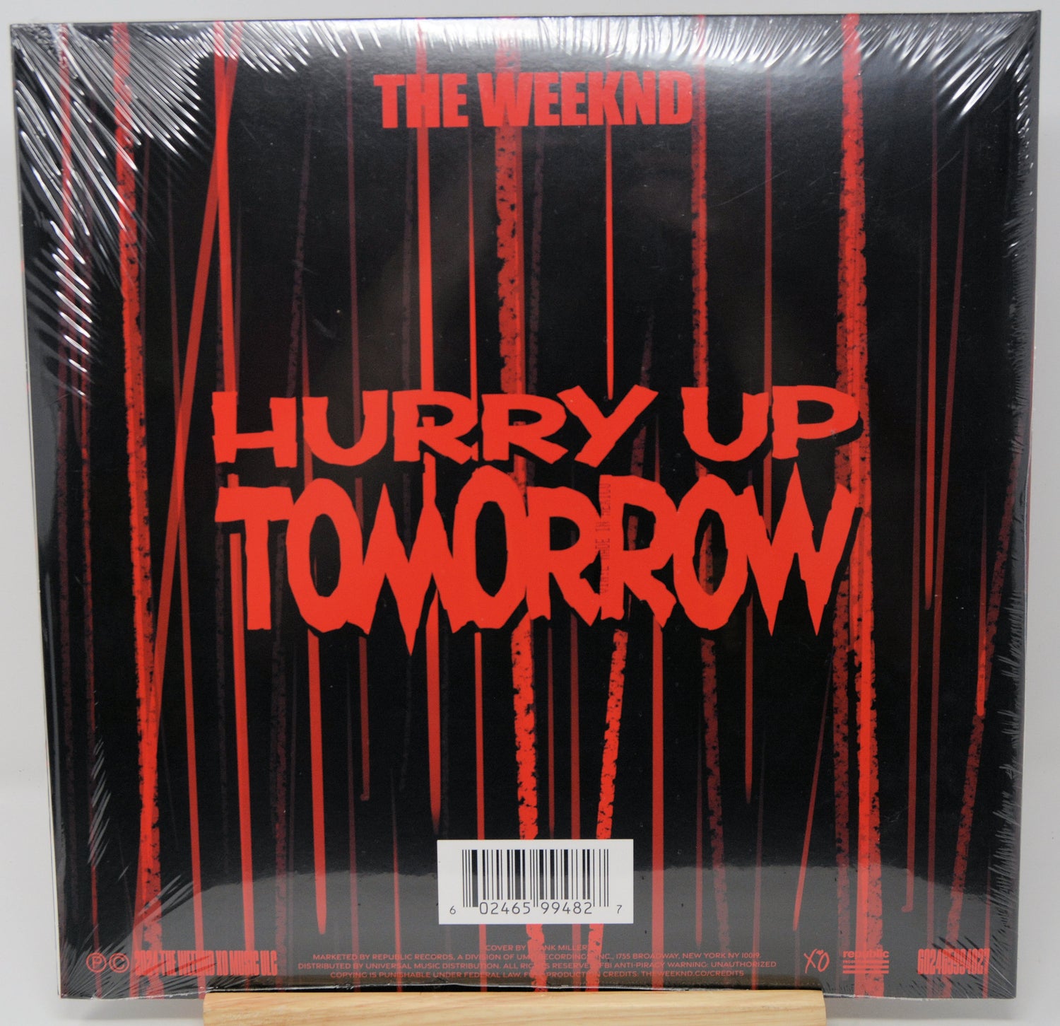 Vinyl record cover for 'Hurry Up Tomorrow' by The Weeknd with red text on a black background.