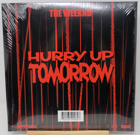 Vinyl record cover for 'Hurry Up Tomorrow' by The Weeknd with red text on a black background.