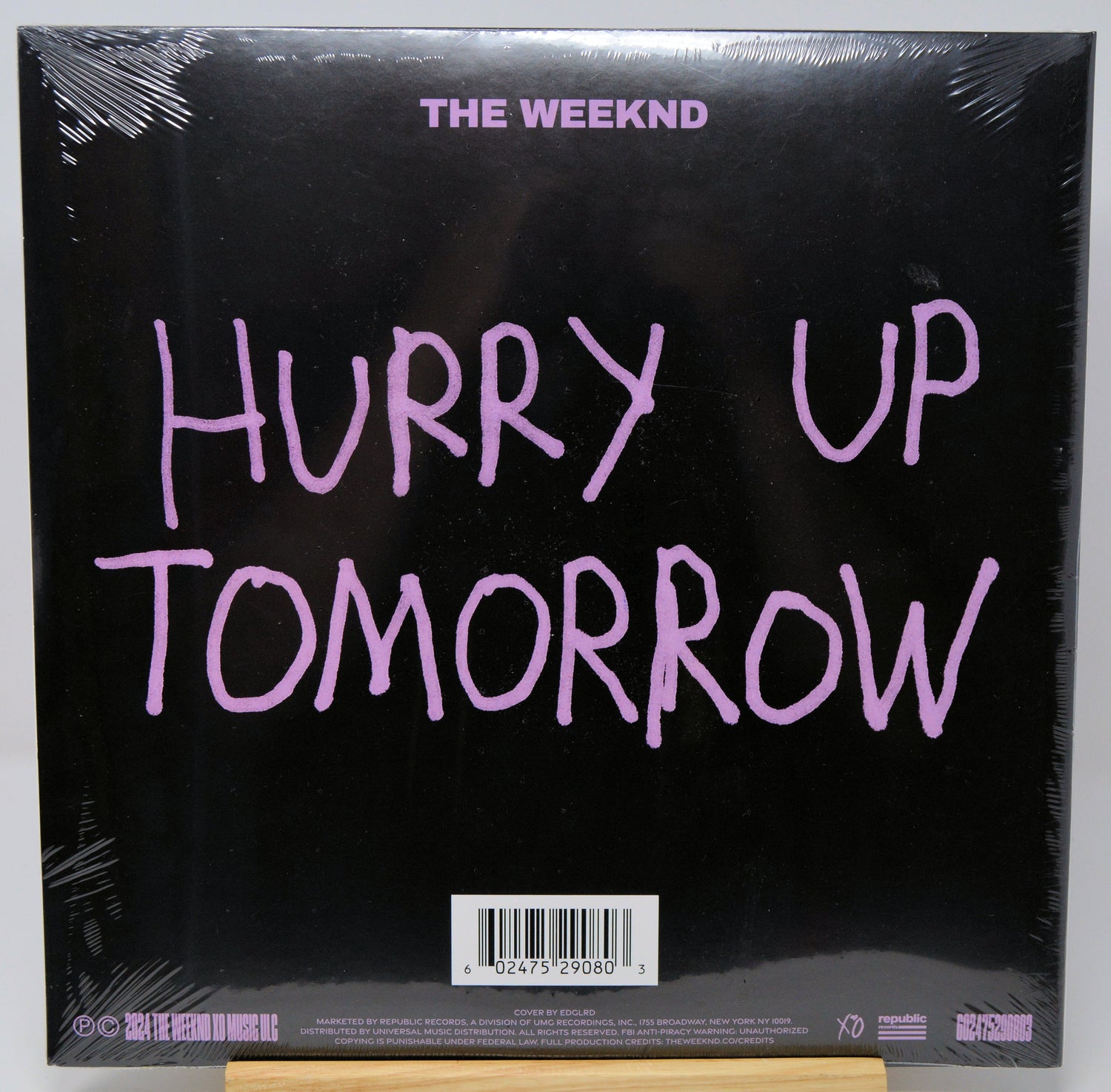 Back cover of 'Hurry Up Tomorrow' by The Weeknd with pink text on a black background.