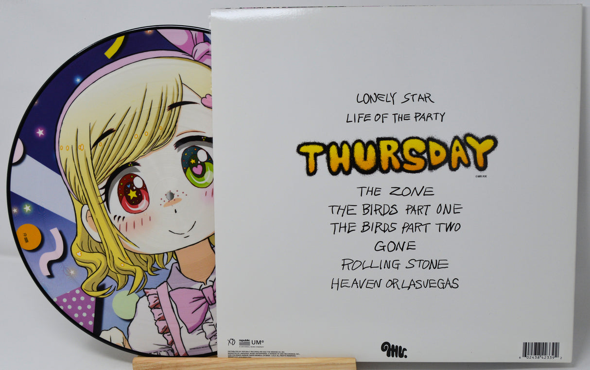 Vinyl record with a colorful cover featuring a cartoon character and text on a white background.