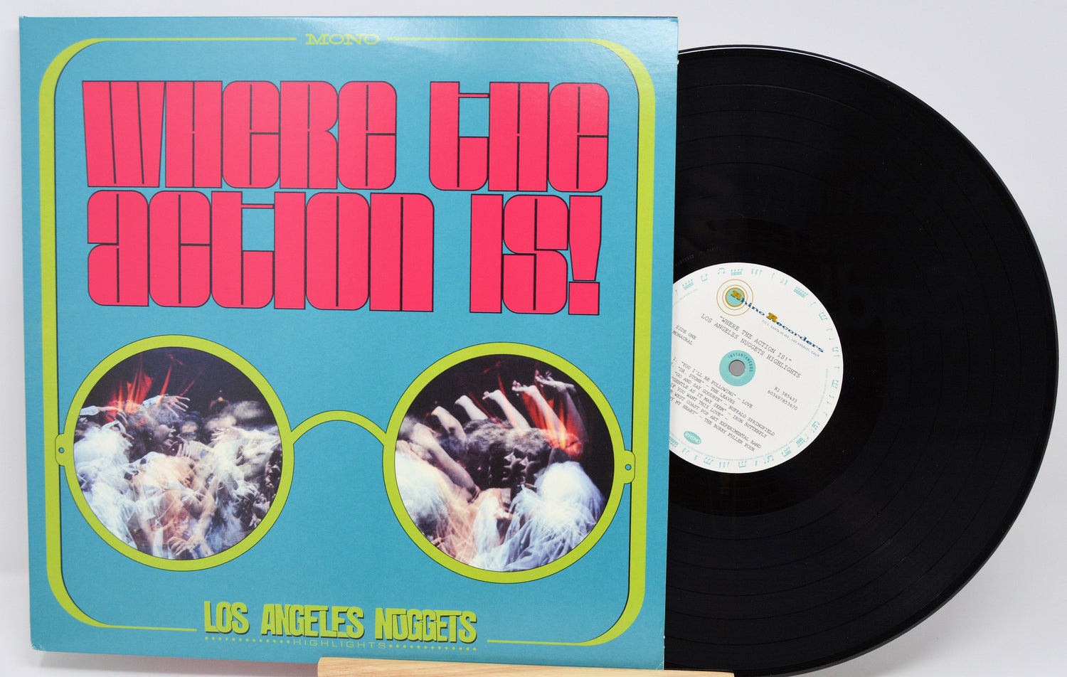 Front cover with bold retro typography and vinyl record of 'Where the Action Is! Los Angeles Nuggets', highlights edition
