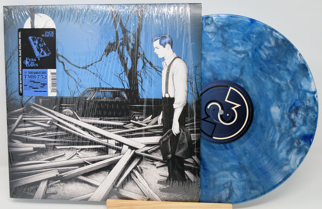 Vinyl record with blue marbled design and cover featuring a person and destroyed building.