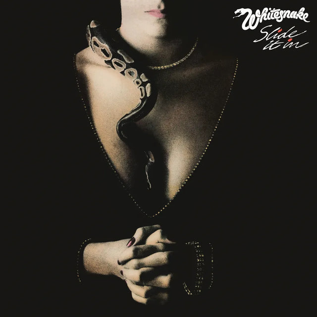 Album cover of 'Slide It In' by Whitesnake with a black and white design.