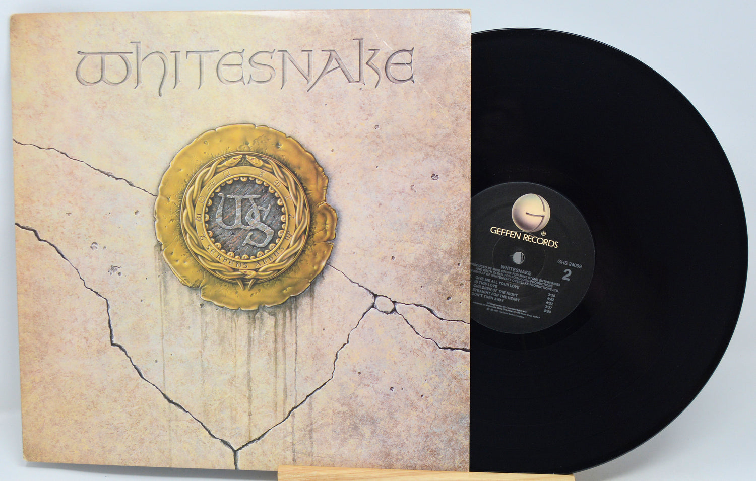 Vinyl record with red cover featuring artistic design and text
