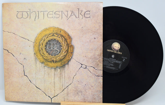 Vinyl record with red cover featuring artistic design and text
