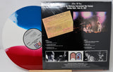 Vinyl record with a colorful disc and cover featuring concert images and text.