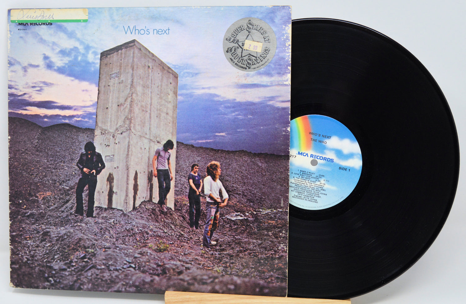 Vinyl record with cover showing a group of people in a desert landscape