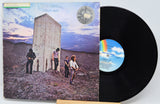 Vinyl record with cover showing a group of people in a desert landscape