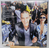 Vinyl record cover with a man and woman in front of a crowd, with text on the left side.