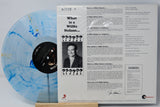 Vinyl record album shown with the back cover and a translucent marbled blue-and-white record partially visible behind it, photographed on a white background.