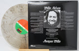 Willie Nelson 'Shotgun Willie' vinyl record LP shown with the back cover standing upright and the record partially pulled out. The record is translucent smoky gray with a green and orange label, and the back cover is black with white text and a black-and-white portrait.
