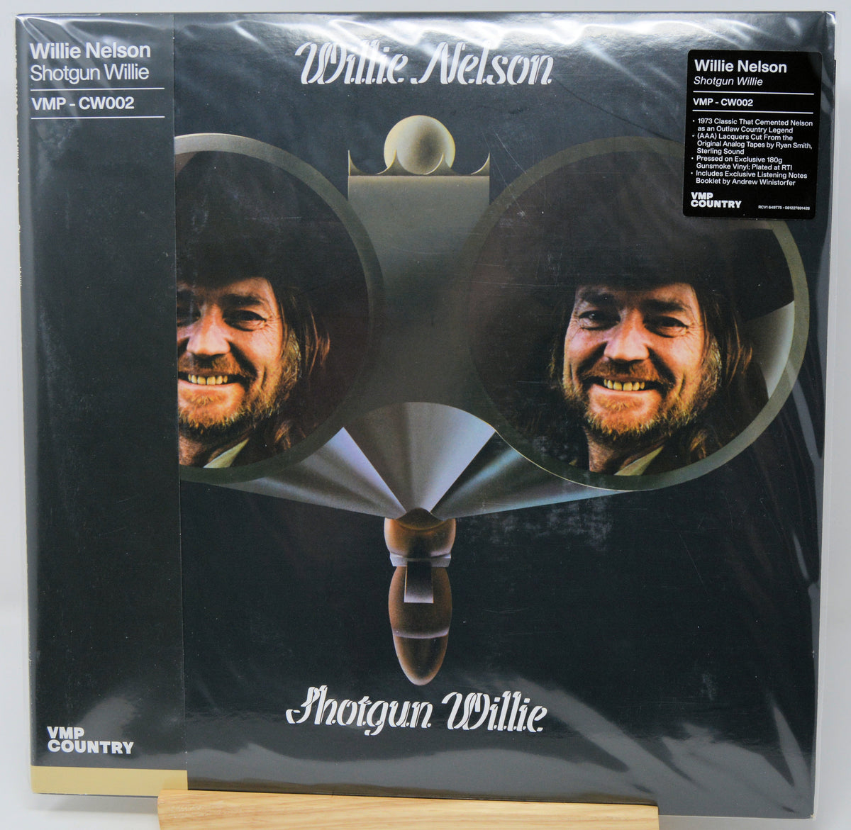 Willie Nelson 'Shotgun Willie' vinyl record LP in its shrink wrap, featuring the album cover artwork with two circular portraits of Willie Nelson and a wooden stand supporting the sleeve.