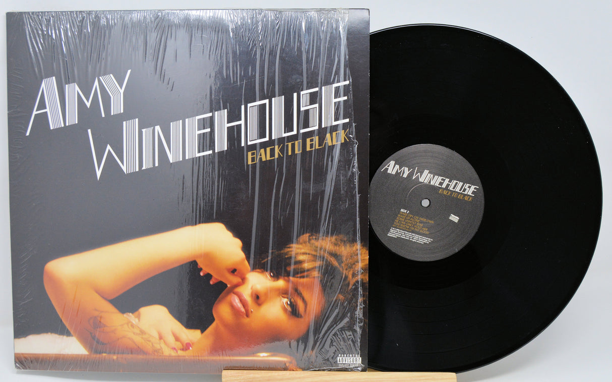 Vinyl record and cover of Amy Winehouse's 'Back to Black' on a light gray background