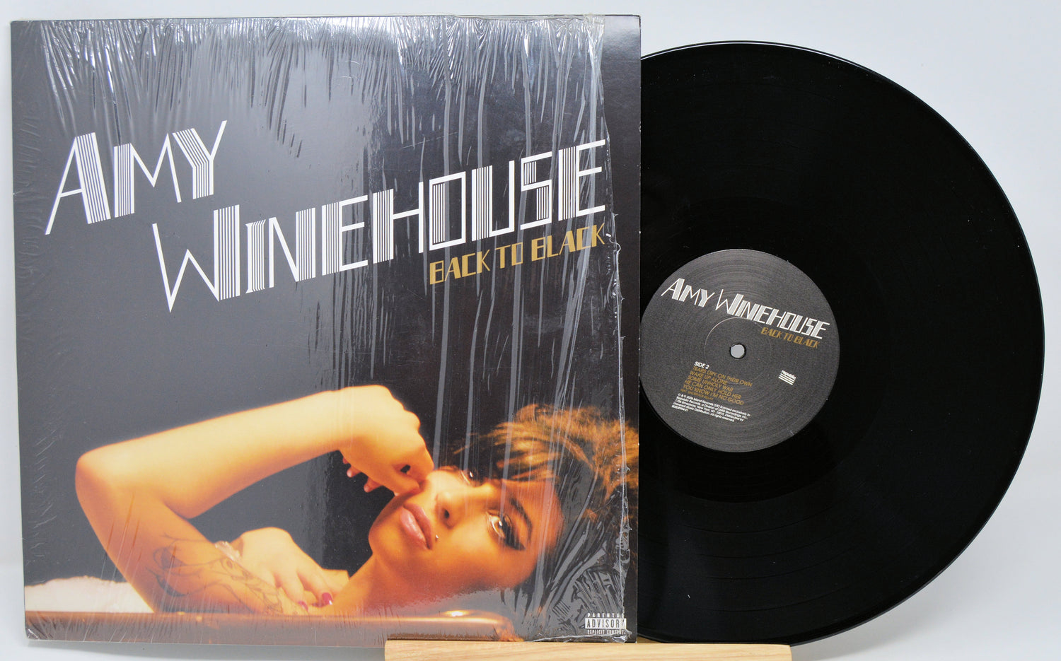 Vinyl record and cover of Amy Winehouse's 'Back to Black' on a light gray background