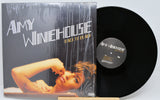 Vinyl record and cover of Amy Winehouse's 'Back to Black' on a light gray background
