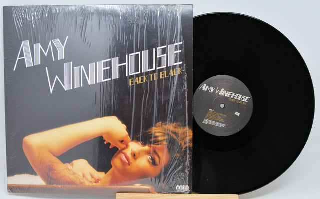 Vinyl record and cover of Amy Winehouse's 'Back to Black' on a light gray background